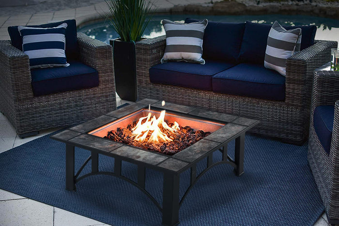 Outdoor patio setting with wicker furniture and a fire pit.