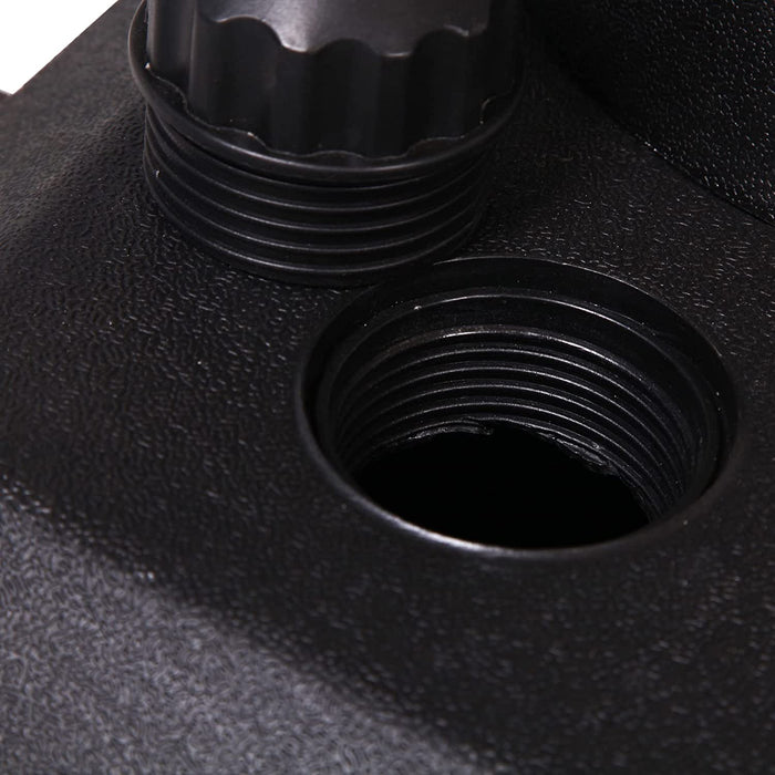 Close-up of a black metal fitting with threaded holes on a textured black surface.