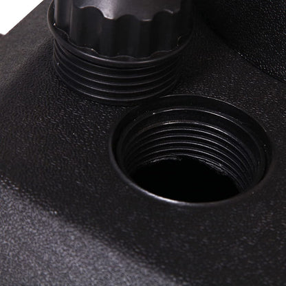 Close-up of a black metal fitting with threaded holes on a textured black surface.