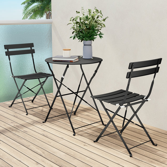 Black metal outdoor furniture set with a small table and two chairs on a wooden deck.