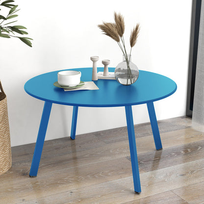 Blue round table with decorative items on a wooden floor