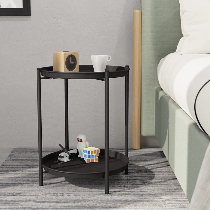 Black side table with decorative items in a bedroom setting