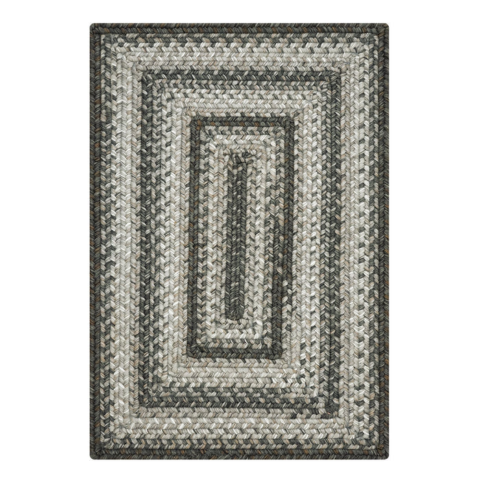 Rectangular braided rug with a striped pattern on a white background