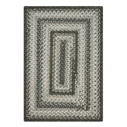 Rectangular braided rug with a striped pattern on a white background