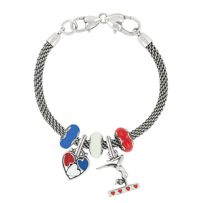 Brighton silver-plated charm bracelet with blue, white, and red enamel beads, heart and gymnast charms on a white background