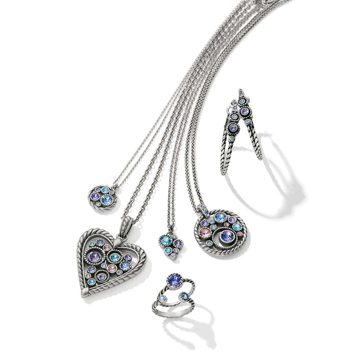 Brighton silver-plated jewelry set styled with heart pendant necklaces, hoop earrings, and rings with multicolor crystals