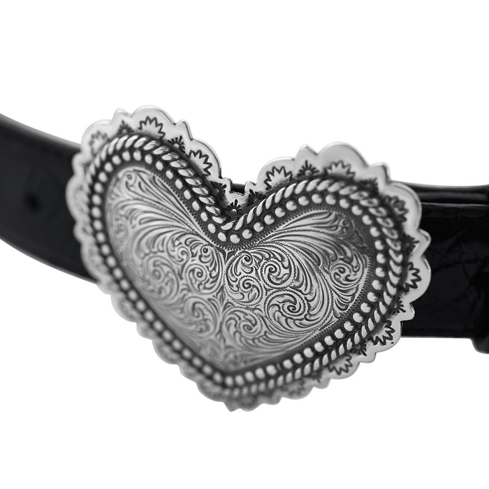 Close-up of Brighton black leather belt with ornate silver-tone heart-shaped buckle featuring engraved scrollwork and beaded border