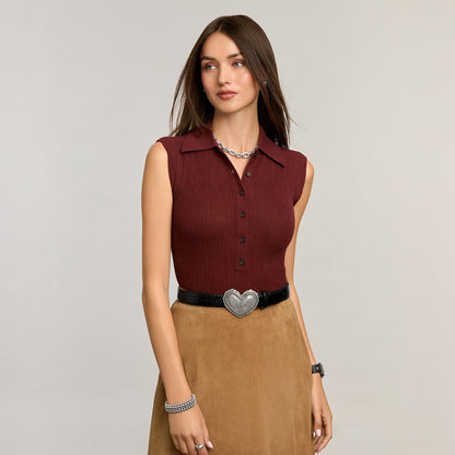 Model wearing a Brighton black leather belt with ornate silver-tone heart-shaped buckle, styled with coordinating Brighton accessories