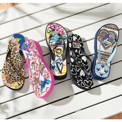 Brighton rubber flip-flops styled in five prints including leopard, floral, graffiti, hearts, and tile patterns on slatted wood
