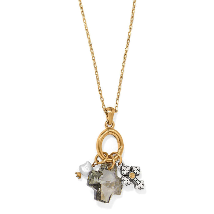 Brighton charm necklace with crystal cross, potato pearl, and silver cross charms on gold-tone chain on a white background