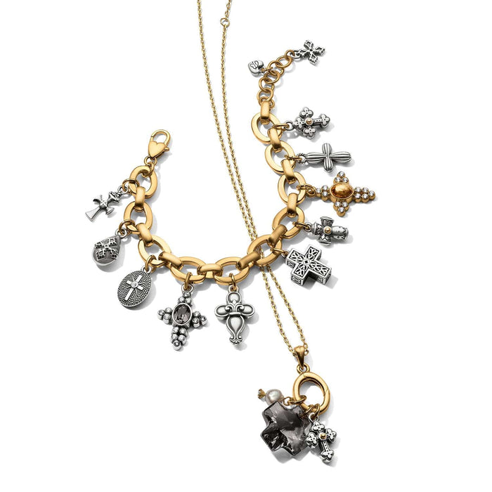 Brighton two-tone charm bracelet and necklace styled with assorted cross charms and crystal pendant on white background