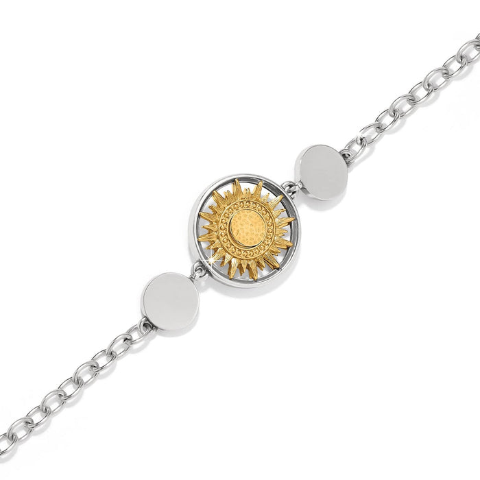 Brighton bracelet with two-tone sunburst medallion, silver-tone disc accents, and chain links on a white background