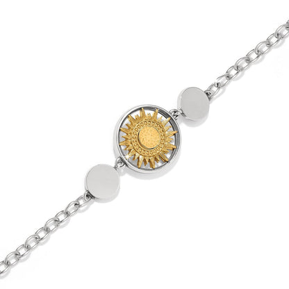 Brighton bracelet with two-tone sunburst medallion, silver-tone disc accents, and chain links on a white background