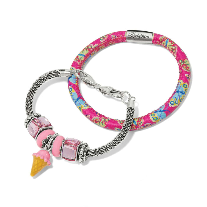 Brighton bracelets with pink butterfly print band and silver-plated mesh chain with crystal beads and enamel ice cream charm on a white background