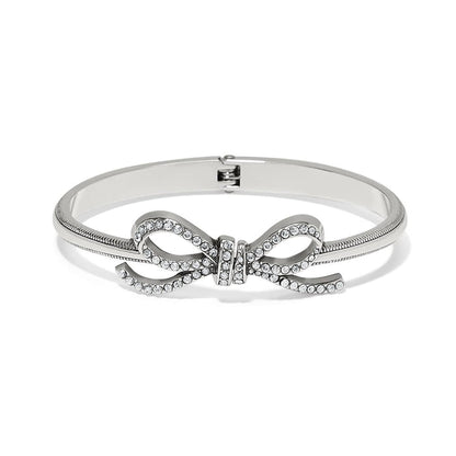 Brighton bangle bracelet with silver-plated finish and crystal-encrusted bow centerpiece on a white background