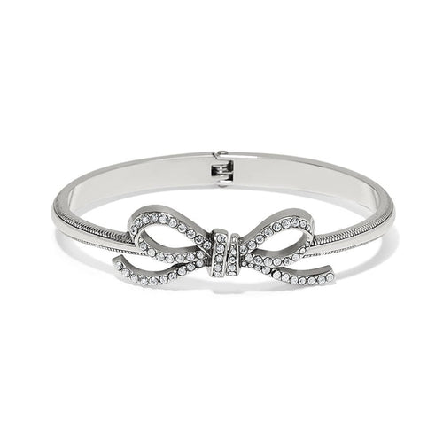 Brighton bangle bracelet with silver-plated finish and crystal-encrusted bow centerpiece on a white background