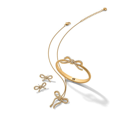 Brighton bow-themed jewelry set with gold-plated necklace, bangle bracelet, and stud earrings featuring crystals on a white background