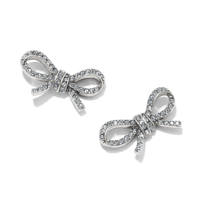 Brighton stud earrings shaped like silver-plated bows with pavé crystal accents and knotted centers on a white background