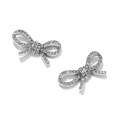 Brighton stud earrings shaped like silver-plated bows with pavé crystal accents and knotted centers on a white background