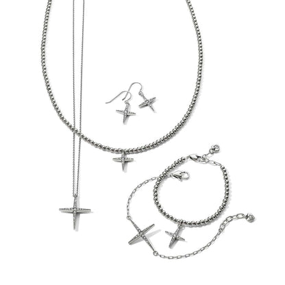 Brighton silver-plated cross jewelry set styled with beaded necklace, bracelets, and drop earrings featuring crystal accents