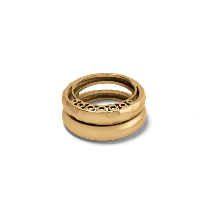 Brighton stacked rings in gold-tone with hammered band, openwork circle detail, and smooth domed band on a white background
