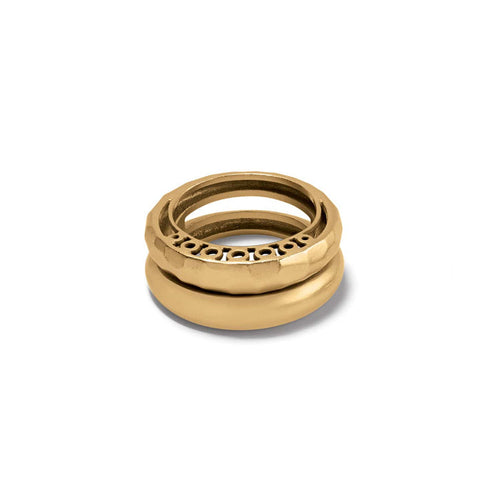 Brighton stacked rings in gold-tone with hammered band, openwork circle detail, and smooth domed band on a white background