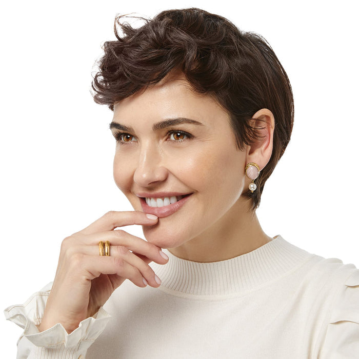 Model wearing Brighton drop earrings with pink oval stones, gold-tone frames, and dangling pearl accents