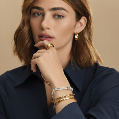 Model wearing a Brighton silver beaded bracelet with Grateful bar and crystal accents alongside coordinating Brighton accessories