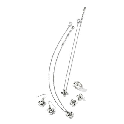 Brighton silver-plated jewelry set styled with knot-motif necklace, earrings, ring, and butterfly pendant on white background