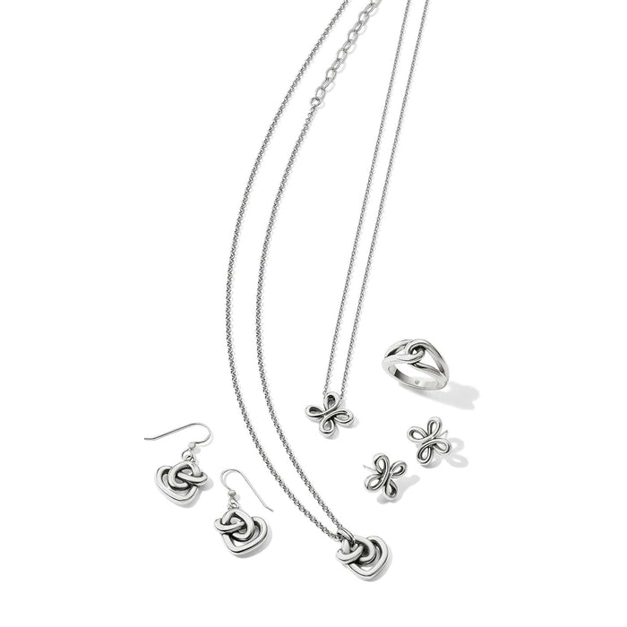 Brighton silver-plated jewelry set styled with matching necklaces, drop earrings, stud earrings, and a ring on a white background