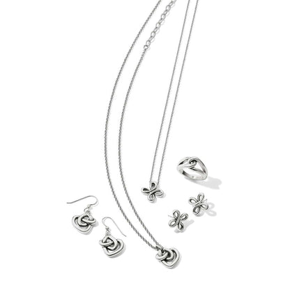 Brighton silver-plated jewelry set styled with matching necklaces, drop earrings, stud earrings, and a ring on a white background