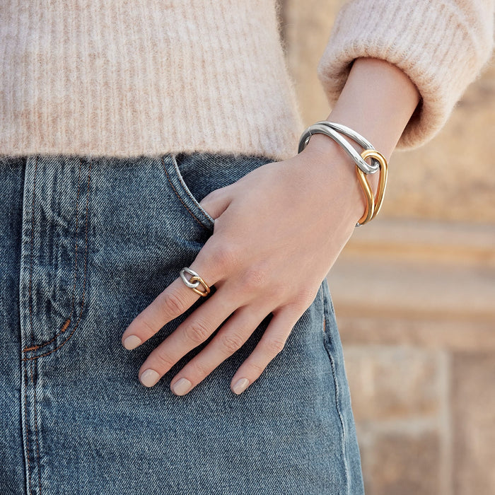 Model wearing a Brighton two-tone interlocking cuff bracelet paired with a matching two-tone silver and gold ring