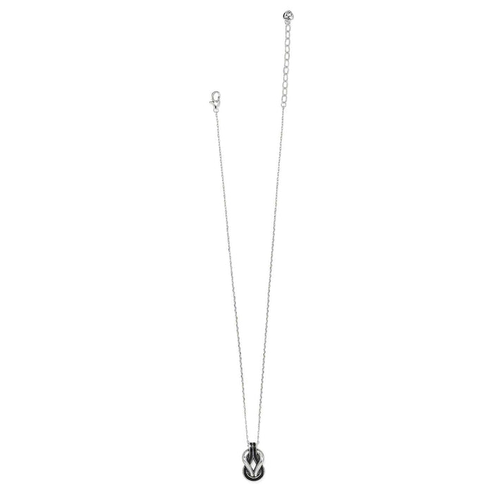 Brighton pendant necklace with silver-plated chain and black enamel knot pendant with silver accents on a white background