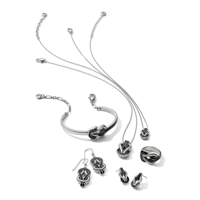 Brighton silver-plated jewelry set styled with matching knot-motif necklaces, bracelet, earrings, and ring with black enamel