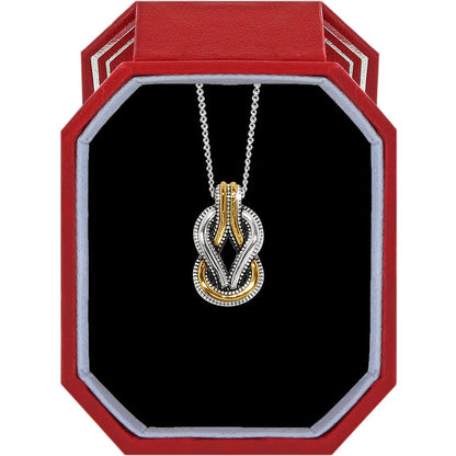 Brighton two-tone knot pendant necklace with silver and gold interlocking loops displayed in a red gift box
