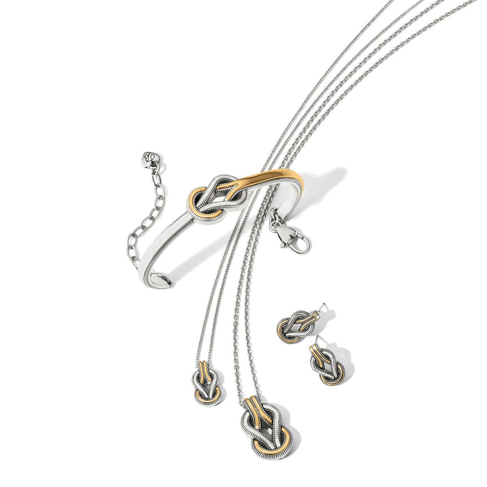 Brighton two-tone jewelry set styled with matching knot-design bracelet, necklaces, and earrings on a white background
