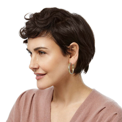 Model wearing a Brighton hoop earring with two-tone silver and gold finish and textured enamel detail