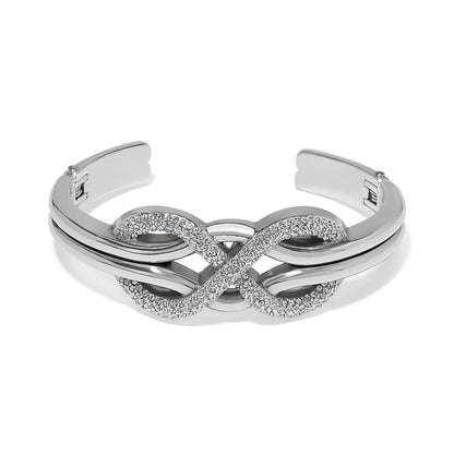 Brighton silver-plated cuff bracelet with crystal-pavé infinity design at the center on a white background