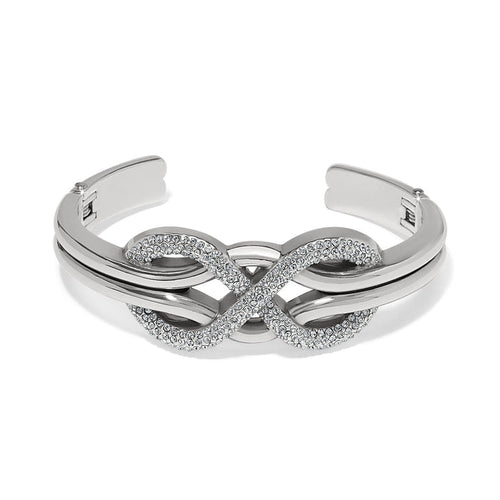 Brighton silver-plated cuff bracelet with crystal-pavé infinity design at the center on a white background