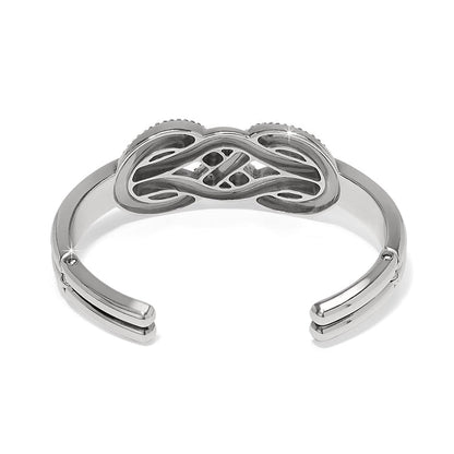 Brighton silver-plated cuff bracelet shown from the back with openwork knot centerpiece and hinged sides on a white background