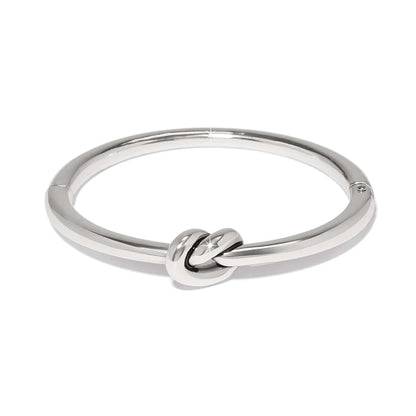 Brighton bangle bracelet with silver-tone polished finish and central love knot design on a white background