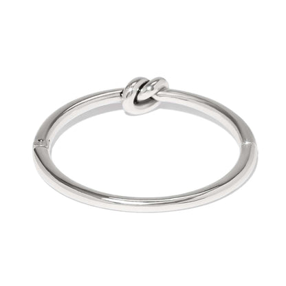 Brighton bangle bracelet with silver-plated finish and central knot detail, shown from a side angle on a white background