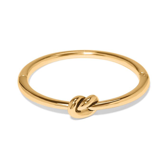 Brighton gold-plated bangle bracelet with polished knot accent at the front on a white background