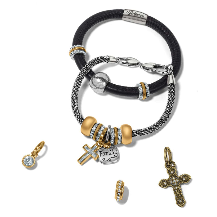 Brighton bracelets styled with gold-plated crystal charms and cross charms on a white background