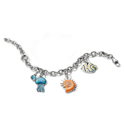 Brighton charm bracelet with enamel jellyfish, nautilus shell, and fish charms with crystals, silver-plated chain on a white background