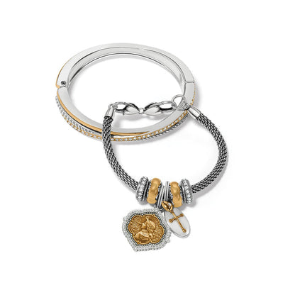 Brighton two-tone bangle and charm bracelet set with crystals and gold medallion cross charms on a white background