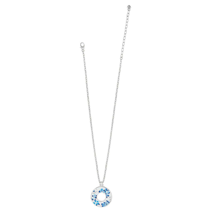 Brighton pendant necklace with silver-plated chain and circular pendant featuring blue enamel floral design on a white background