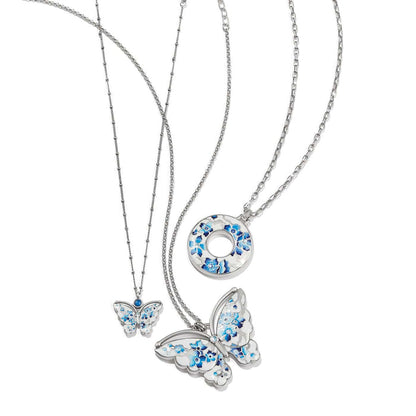 Brighton silver-plated necklaces with blue floral enamel butterfly and circle pendants featuring crystal accents on a white background