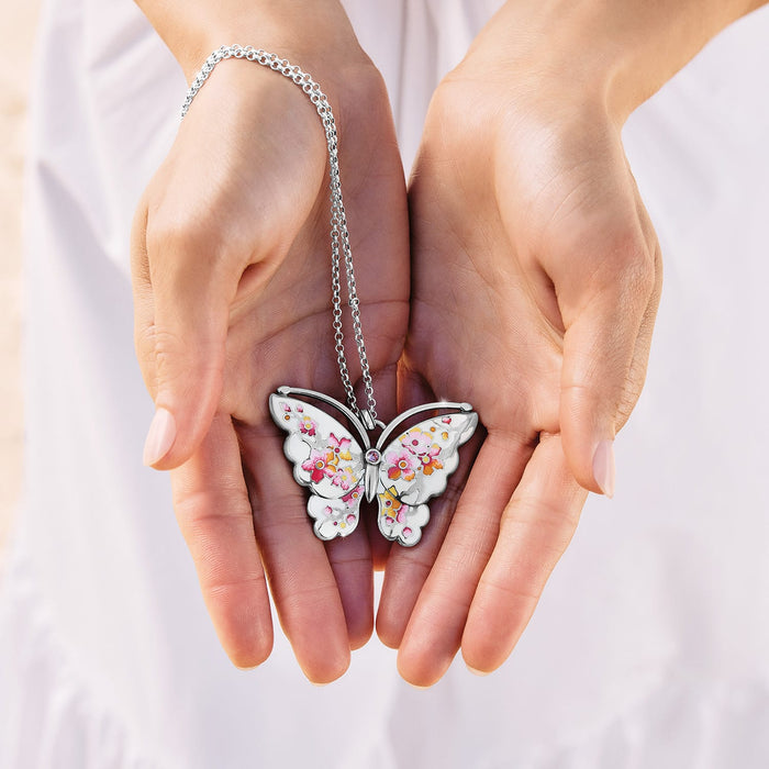 Model with a Brighton silver-plated butterfly pendant necklace featuring floral enamel wings and crystal accent