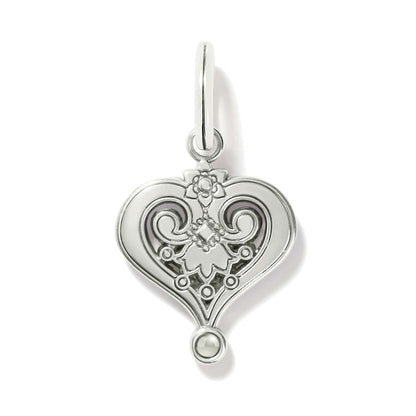 Brighton heart charm shown from the back with silver-plated scrollwork, floral detail, and small bead accent on a white background